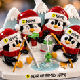 Load image into Gallery viewer, Decorative penguin figurine set with Santa hats and fishing rods on a blurred background
