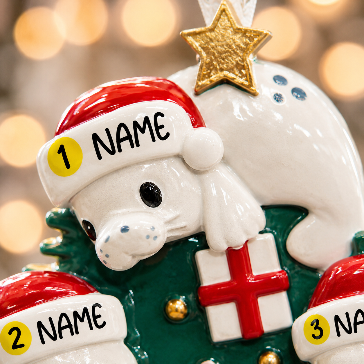 Decorative Christmas ornament with a reindeer wearing a Santa hat and holding a gift, with 'NAME' labels.