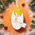 Load image into Gallery viewer, Personalized ballet girl Christmas ornament featuring a cute ballerina character in a pink tutu dress with heart details, customizable name area on the front banner and customizable year area below, glossy finish with raised 3D front details and flat 2D back, white hanging ribbon, displayed on a snowy holiday background with pine branches and festive decorations.
