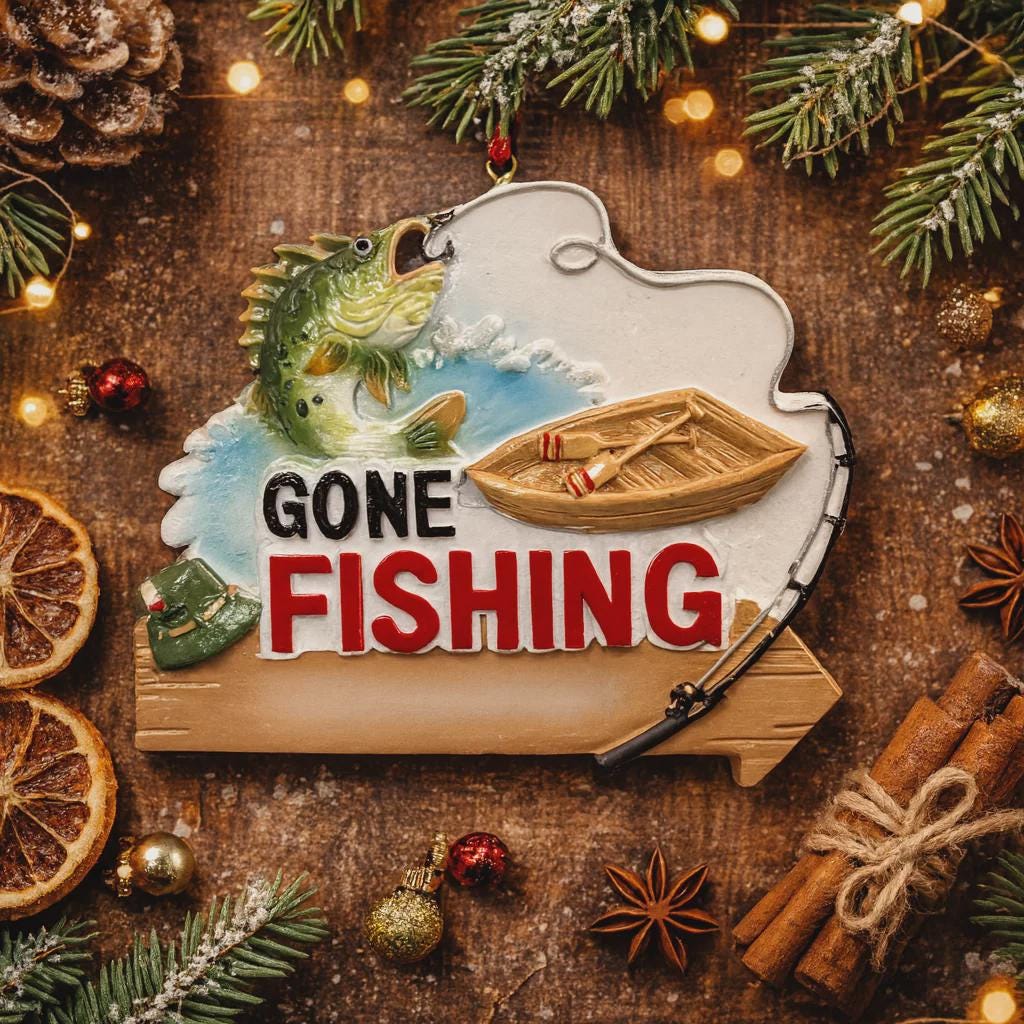 Decorative sign with 'Gone Fishing' text surrounded by Christmas decorations on a wooden background.