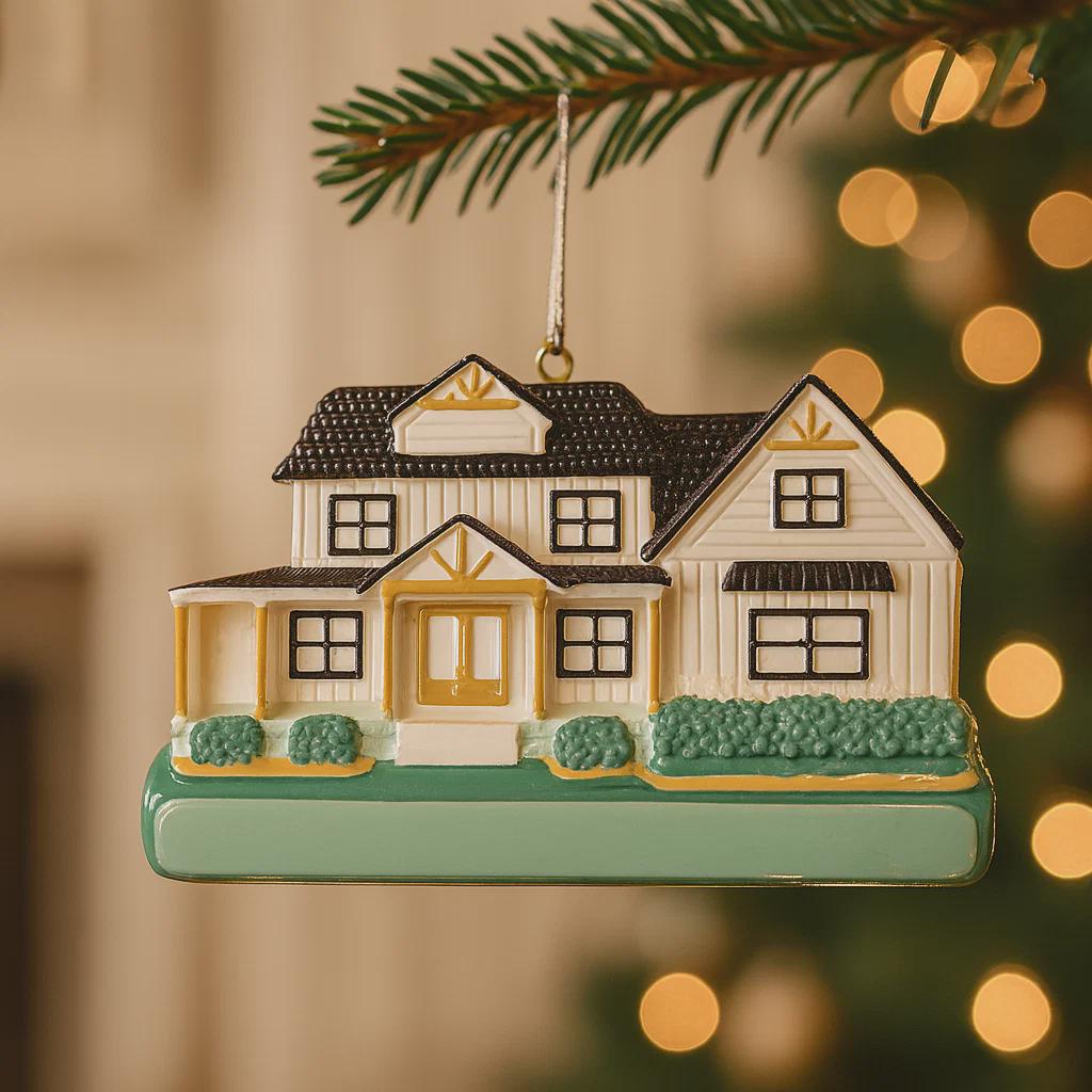 Decorative house ornament hanging on a tree with blurred lights in the background