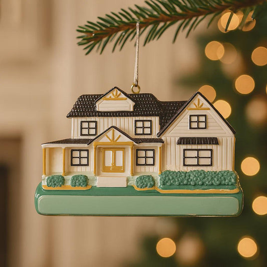 Decorative house ornament hanging on a tree with blurred lights in the background