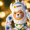 Load image into Gallery viewer, Personalized baby boy llama ornament featuring a cute smiling llama wearing a winter hat and surrounded by a festive wreath with colorful holiday lights. Soft blue and white tones create a cozy winter look. Handwritten personalization includes baby name and Baby’s First Christmas with year. Mostly 2D ornament with raised 3D details on the front only, lightweight and perfect for Christmas trees, nursery decor, and baby keepsakes.
