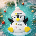 Load image into Gallery viewer, Personalized Baby Penguin First Christmas Ornament featuring a sweet penguin wearing a soft pink winter hat, sitting on a snowy base. The baby’s name is displayed on the hat and the year is placed on the belly, creating a meaningful keepsake for a newborn’s first holiday season. With bright yellow feet, soft winter details, and charming 3D design, this ornament is perfect for baby girls celebrating their very first Christmas and makes a thoughtful holiday gift for new parents.
