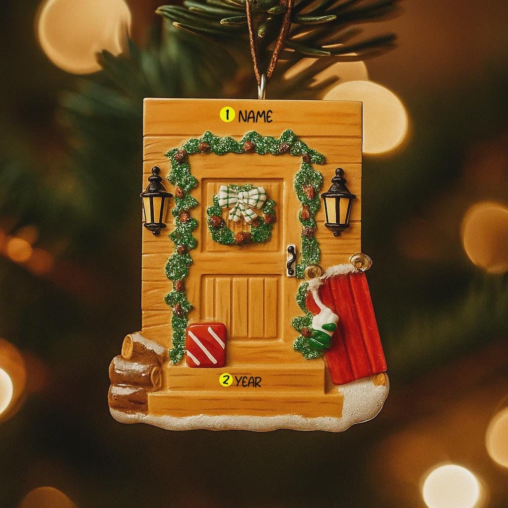 Decorative Christmas ornament shaped like a wooden door with festive decorations on a blurred Christmas tree background.
