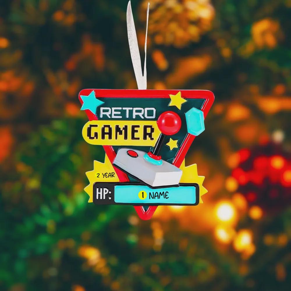 Personalized retro gamer Christmas ornament featuring a classic arcade style joystick and bold gaming icons. Raised 3D front details create depth while the back remains flat for easy hanging. Custom name and year placement make this ornament a fun and nostalgic keepsake for gamers and holiday tree decor.