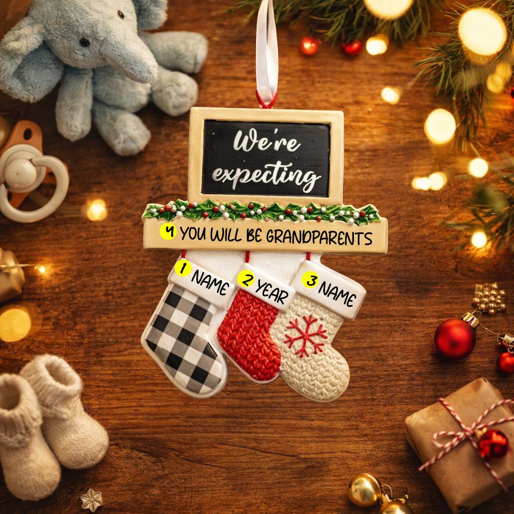 Decorative sign with stockings and text on a wooden surface with Christmas decorations.