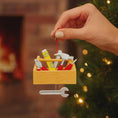 Load image into Gallery viewer, Personalized handyman ornament featuring a wooden style toolbox filled with tools including hammer wrench pliers and level. Custom name and year displayed on the front. Mostly 2D design with raised 3D tool details on the surface. Perfect Christmas ornament for handyman contractors mechanics and skilled trade workers.
