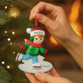 Load image into Gallery viewer, This personalized ice skating boy ornament features a cheerful winter skater wearing festive holiday clothing and gliding across an icy base. The design includes a custom name on the hat and a year displayed on the base, making it a perfect keepsake for celebrating winter memories, first Christmas moments, or a child’s love for ice skating and winter sports.

