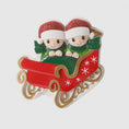 Load image into Gallery viewer, Personalized couple ornament featuring two characters sitting together in a festive sleigh design. This romantic Christmas ornament can be customized with two names and a year or family name, making it perfect for couples, partners, spouses, fiancés, or loved ones. Ideal for celebrating love, togetherness, Valentine’s Day, anniversaries, or first holidays together. A meaningful keepsake for couples who want to turn shared moments into lasting holiday memories.

