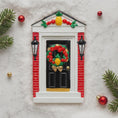 Load image into Gallery viewer, Decorative door with wreath and ornaments on a textured surface
