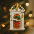 Load image into Gallery viewer, Decorative Christmas ornament resembling a door with wreath and bow, hanging against a blurred festive background.
