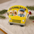 Load image into Gallery viewer, Decorative school bus ornament with children's faces on a snowy background
