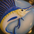 Load image into Gallery viewer, Decorative Sailfish ornament on a blue and white circular background
