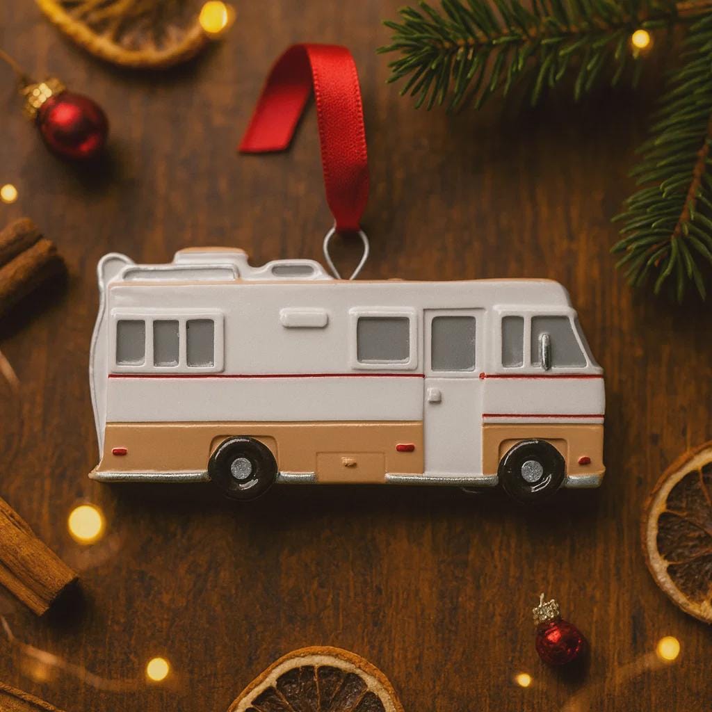 Decorative RV ornament on a wooden surface with Christmas decorations