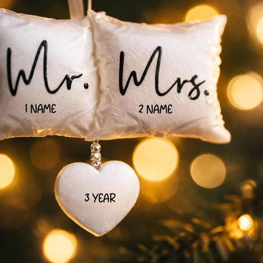 Personalized Mr and Mrs pillow ornament featuring a soft white cushion design with hanging heart detail. A romantic keepsake for newlyweds celebrating their first Christmas married or Valentine’s Day. Perfect wedding gift anniversary decor and couple ornament.