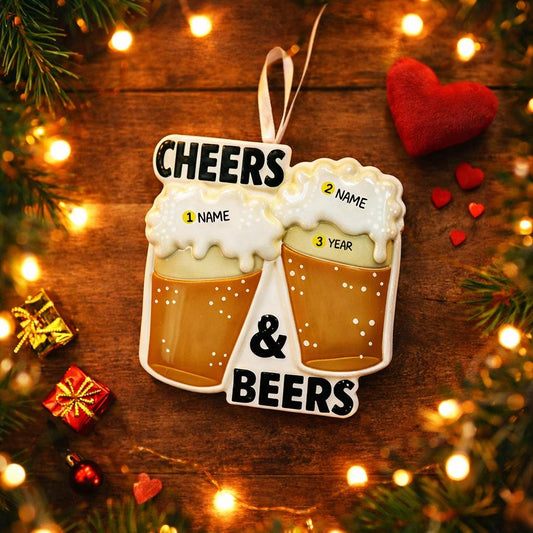 Personalized Cheers and Beers Christmas ornament featuring a raised 3D front with two frothy beer mugs clinking together. The design includes bold “Cheers” and “Beers” lettering, detailed foam texture, and warm amber beer tones. The ornament has a flat 2D back for easy hanging. Hand-added personalization allows two names and a year. Styled on a rustic wooden background with Christmas lights, greenery, and festive decor for a cozy holiday atmosphere.
