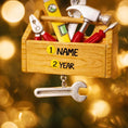 Load image into Gallery viewer, Personalized handyman ornament featuring a wooden style toolbox filled with tools including hammer wrench pliers and level. Custom name and year displayed on the front. Mostly 2D design with raised 3D tool details on the surface. Perfect Christmas ornament for handyman contractors mechanics and skilled trade workers.

