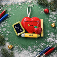 Load image into Gallery viewer, Decorative ornament shaped like a heart with educational elements on a green background with snowflakes and teacher Christmas ornament
