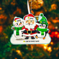 Load image into Gallery viewer, Personalized Christmas ornament with Santa, snowman, and penguin against a blurred festive background.
