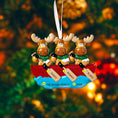 Load image into Gallery viewer, Decorative ornament with three moose in a canoe, personalized with names and a year, against a blurred Christmas tree background.
