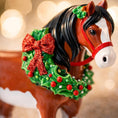 Load image into Gallery viewer, Horse figurine with a Christmas wreath and bow on a blurred lights background

