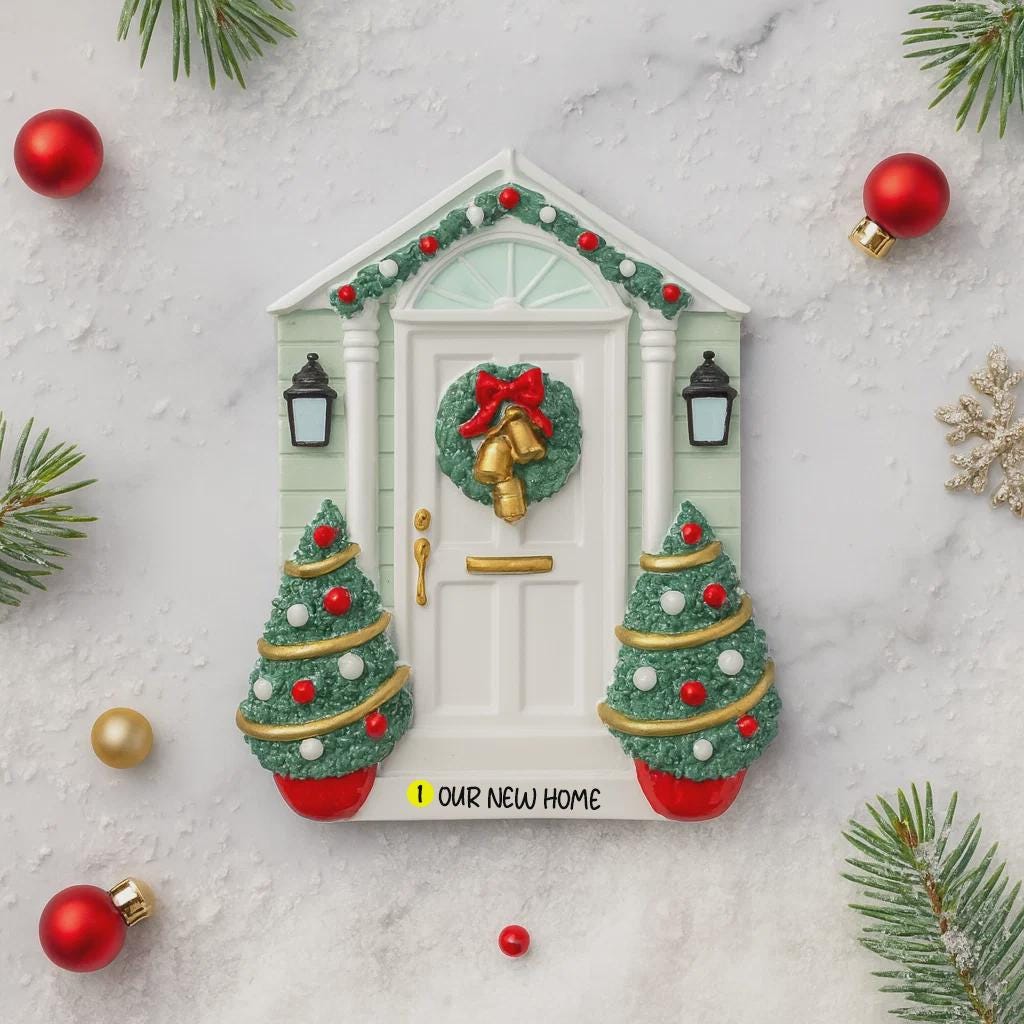 Decorative Christmas door with wreath and ornaments on a marble surface.