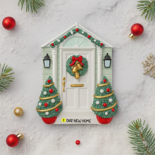 Decorative Christmas door with wreath and ornaments on a marble surface.