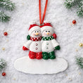 Load image into Gallery viewer, Two snowman ornaments on a snowy background with Christmas decorations.
