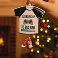 Load image into Gallery viewer, Decorative ornament shaped like a t-shirt with text and gaming controller design, held in front of a Christmas tree.
