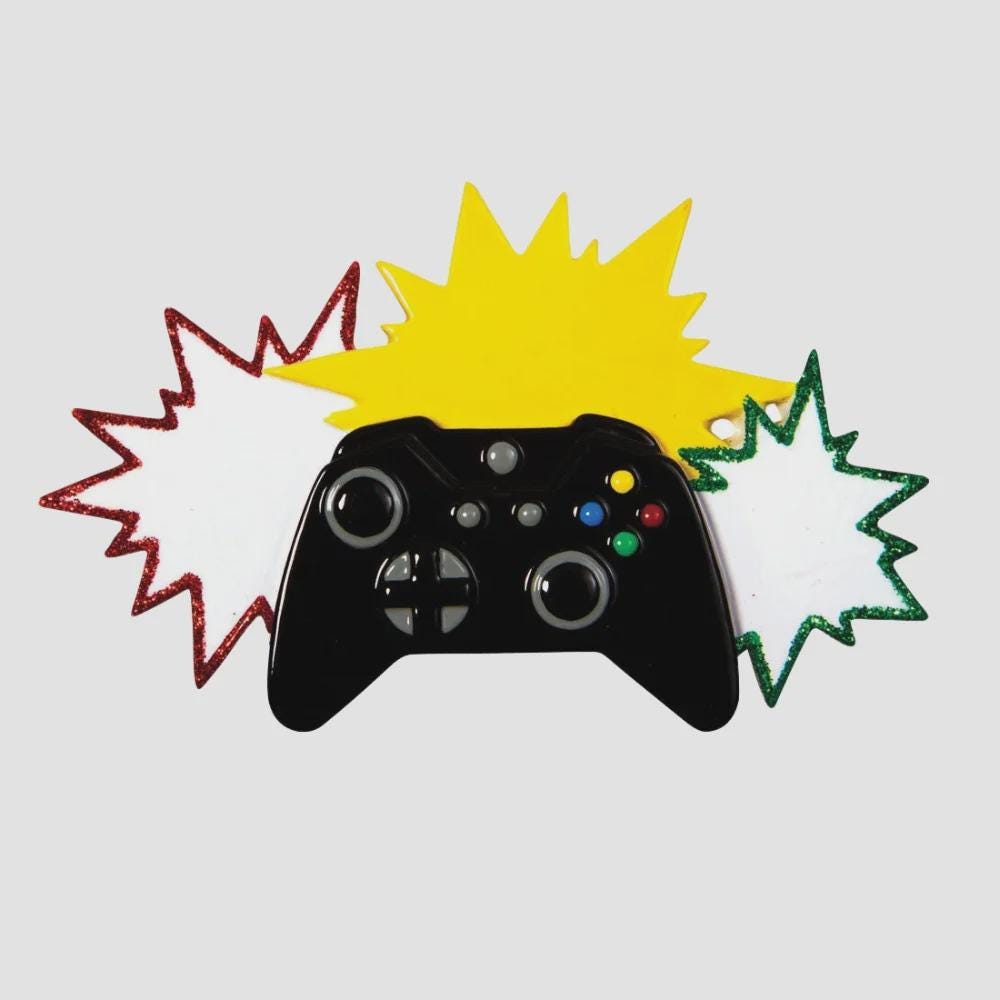Personalized gamer controller Christmas ornament featuring a raised 3D front with detailed game controller design, including realistic buttons, joystick elements, and bold comic style accents. The ornament has a smooth flat 2D back for easy hanging and long lasting durability on the Christmas tree. The design allows personalization with a name and year clearly displayed on the front, making it a unique holiday keepsake. Bright colors and gaming themed details make this ornament perfect for kids, teens, and 