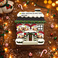 Load image into Gallery viewer, Personalized Christmas ornament with family design on a wooden background with festive decorations.
