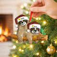 Load image into Gallery viewer, Two sloths in Santa hats on a log ornament with customizable names against a Christmas tree background.
