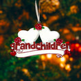 Load image into Gallery viewer, Personalized grandparents Christmas ornament featuring two white heart shapes with custom names, red rose details, glitter red grandchildren lettering and a heartfelt we love you message, designed as a sentimental holiday keepsake for grandparents, displayed on a warm rustic wooden background with cozy Christmas lights, ornaments and festive decor, perfect for celebrating family love and cherished memories during the holiday season
