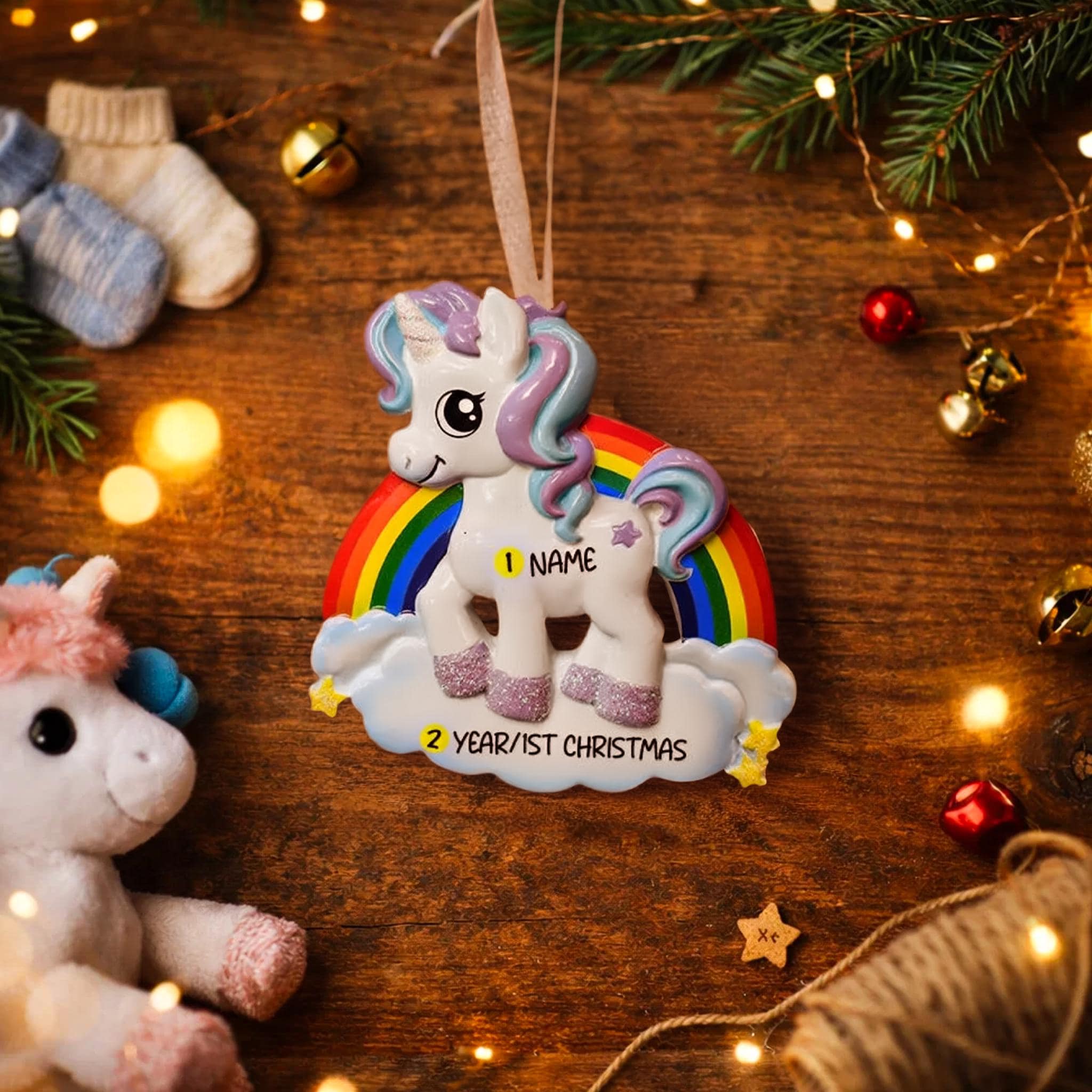 Unicorn ornament with rainbow on a wooden surface with Christmas decorations