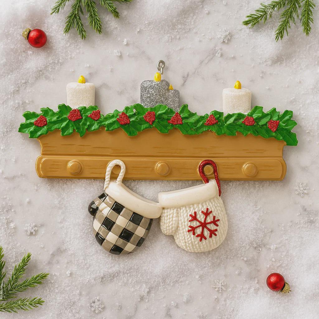 Decorative Christmas ornament with mittens, candles, and holly on a textured surface.