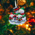 Load image into Gallery viewer, Personalized Christmas ornament with snowman family against a blurred festive background

