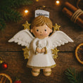 Load image into Gallery viewer, Decorative angel ornament with a dove on a wooden surface with Christmas decorations.
