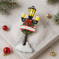 Load image into Gallery viewer, Decorative Christmas street lamp ornament with wreath and bow on a snowy background

