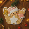 Load image into Gallery viewer, Personalized Baby Girl First Christmas Ornament featuring a detailed 3D front design with a sweet baby resting inside a woven basket, pink nightcap, teddy bear, and hanging star for the year. The baby’s name is added on the hat and the year on the star, creating a meaningful keepsake. Soft pink tones, cozy textures, and dimensional elements make it perfect for newborn girl gifts, baby shower presents, and treasured first Christmas tree memories.
