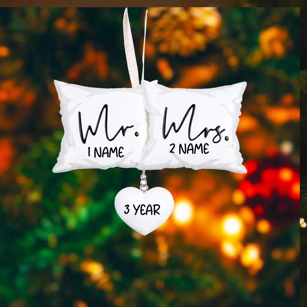 Personalized Mr and Mrs pillow ornament featuring a soft white cushion design with hanging heart detail. A romantic keepsake for newlyweds celebrating their first Christmas married or Valentine’s Day. Perfect wedding gift anniversary decor and couple ornament.