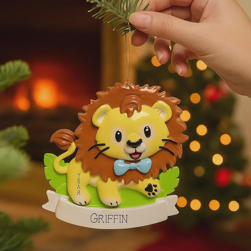 Lion themed Christmas ornament designed with a playful and colorful style, perfect for kids and animal lovers. This ornament features a lion character standing on a grassy base with a glossy finish and cheerful details. The design includes a personalization option, allowing a custom name and year to be added, making it a meaningful keepsake for children or family holiday traditions. Ideal for Christmas trees, nursery decor, or as a unique personalized gift for animal themed celebrations.