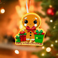 Load image into Gallery viewer, Gingerbread man ornament for 'Baby's First Christmas' with a blurred Christmas tree background.
