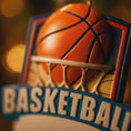 Load image into Gallery viewer, Personalized basketball Christmas ornament featuring an orange basketball and hoop design with customizable name area on the front banner and customizable year area on the basketball, glossy finish with raised 3D front details and flat 2D back, white hanging ribbon, displayed on a snowy basketball court themed holiday background with pine branches and festive decorations.
