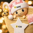 Load image into Gallery viewer, Personalized Baby Girl First Christmas Ornament featuring a detailed 3D front design with a sweet baby resting inside a woven basket, pink nightcap, teddy bear, and hanging star for the year. The baby’s name is added on the hat and the year on the star, creating a meaningful keepsake. Soft pink tones, cozy textures, and dimensional elements make it perfect for newborn girl gifts, baby shower presents, and treasured first Christmas tree memories.
