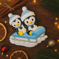 Load image into Gallery viewer, Decorative penguin figurine on a sled with Christmas decorations around
