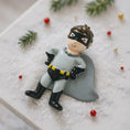 Load image into Gallery viewer, Personalized superhero boy Christmas ornament featuring a mask, cape and custom name. Cute holiday decor for boys, perfect for Christmas trees and gift-giving. Add name and year to create a unique keepsake. Display photos are AI-generated; please check the first image for the original product.
