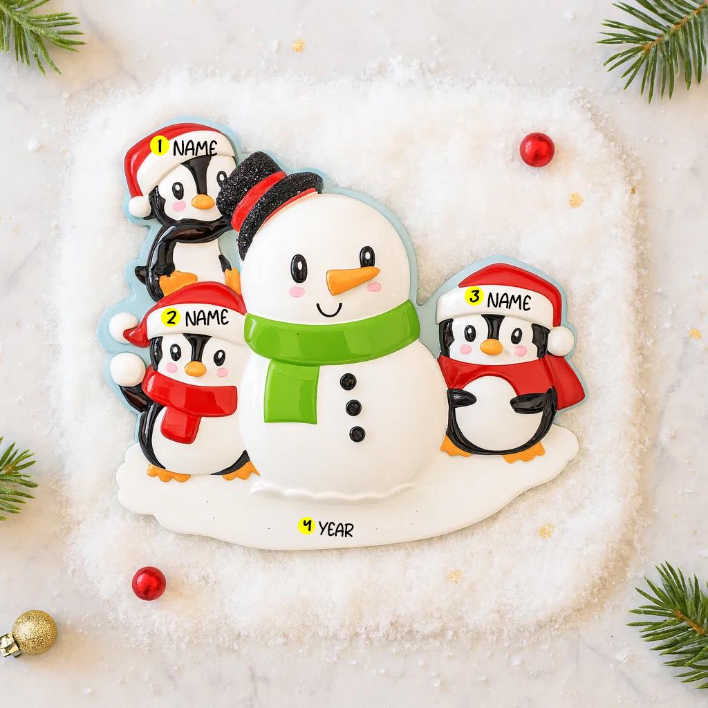 Personalizable snowman and penguin Christmas ornament on a snowy background with tree branches.