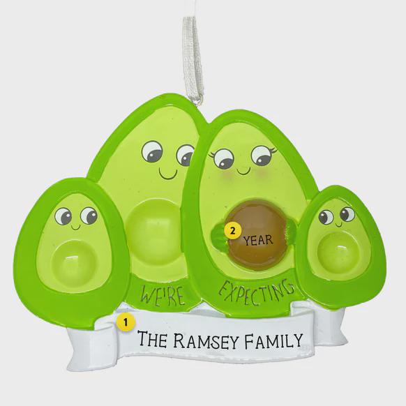 Avocado family ornament with 'We're Expecting' message on a white background
