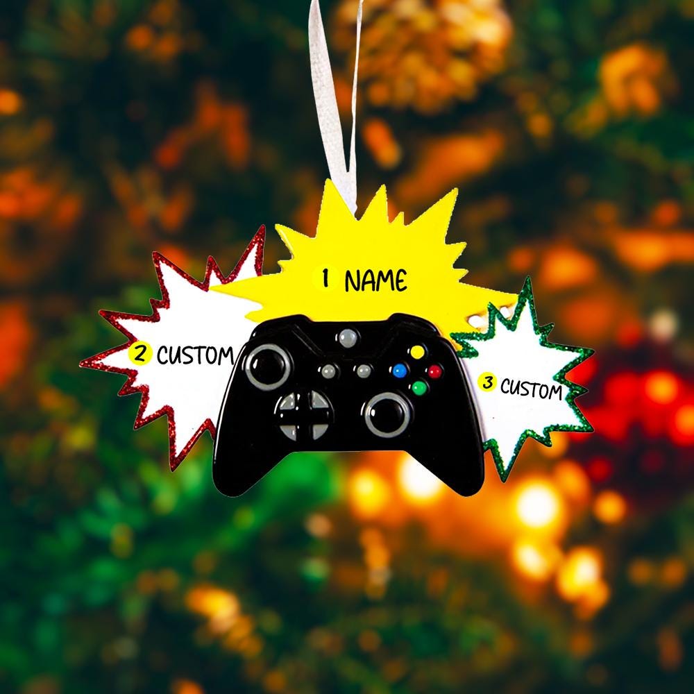 Personalized gamer controller Christmas ornament featuring a raised 3D front with detailed game controller design, including realistic buttons, joystick elements, and bold comic style accents. The ornament has a smooth flat 2D back for easy hanging and long lasting durability on the Christmas tree. The design allows personalization with a name and year clearly displayed on the front, making it a unique holiday keepsake. Bright colors and gaming themed details make this ornament perfect for kids, teens, and 